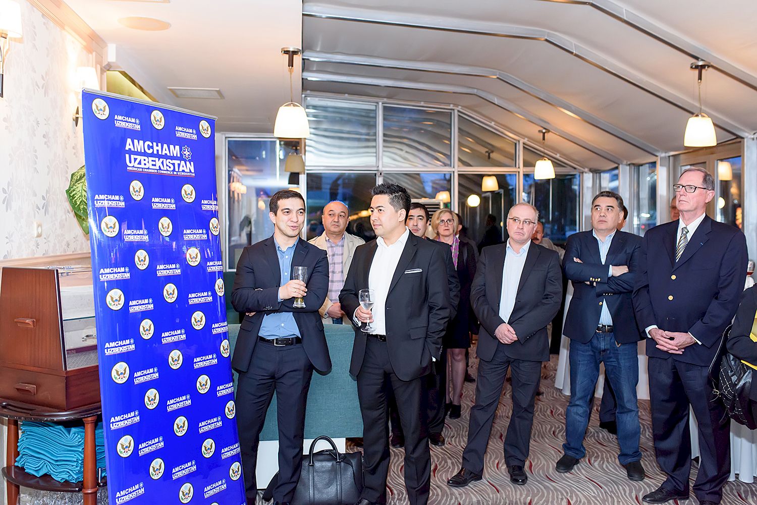 Guests standing in groups at a chamber business mixer